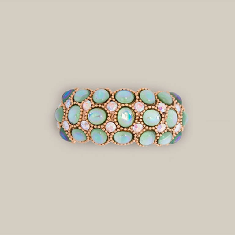 Claire Deve Vintage Crystal Embellished Cuff.  	

Astonishing gold-tone metal cuff from Claire Deve Vintage featuring green and blue glass crystal embellishing. Will step up any simple outfit to a new level of luxury.

Colour: Gold

Material: