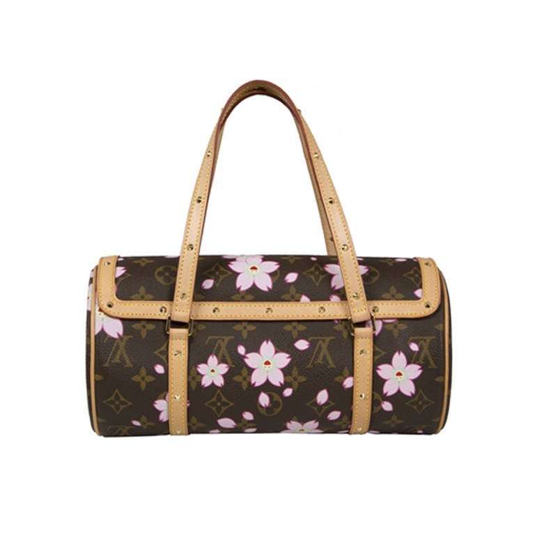 Monogram and cherry blossum print canvas barrel handbag from Louis Vuitton. This reinterpretation by Marc Jacobs and Takashi Murakami features flap closure with magnetic studs, bow detail with monogram lock and a beige suede interior.

Colour: