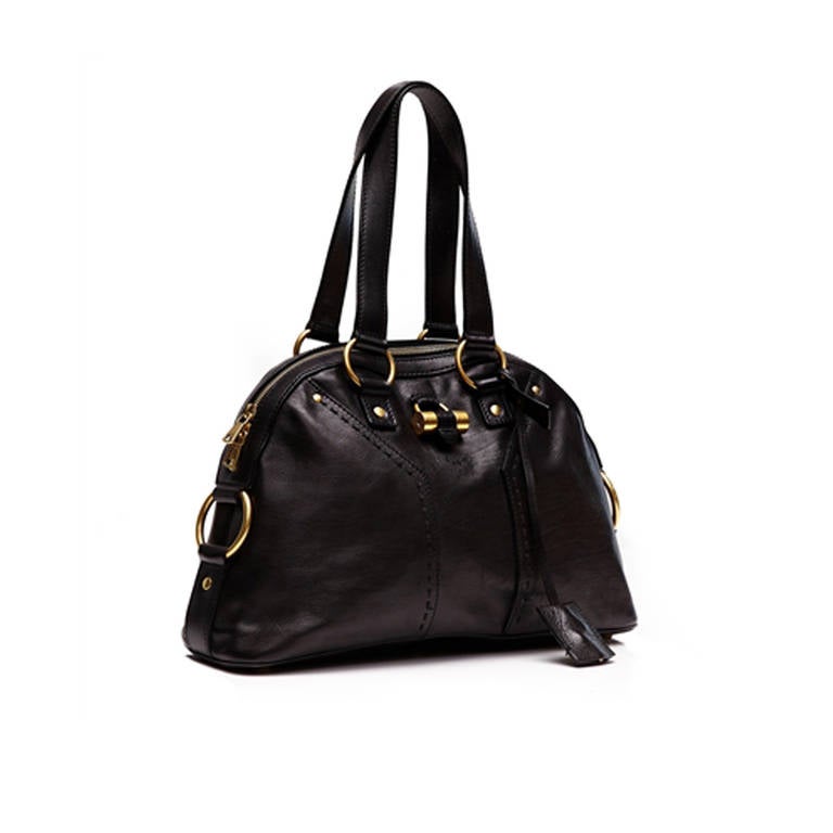 Yves Saint Laurent Black Bag. Add some luxury to your handbag collection with this blackleather ‘Muse’ shoulder bag from Yves Saint Laurent  featuring gold hardware, zip closure and zip interior pocket. 

Material: Black Leather

Measurements: