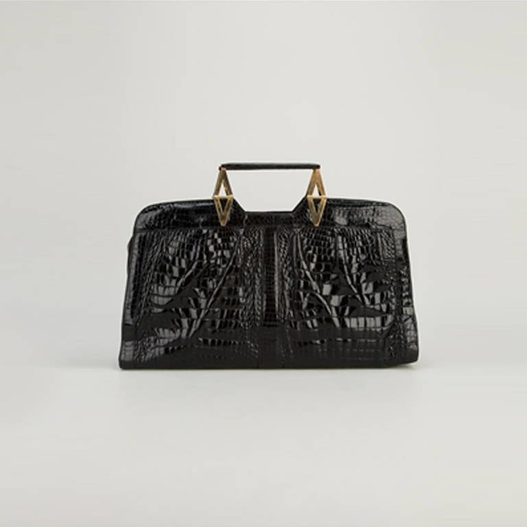 Vintage Crocodile Leather Handbag. Add a dash of exquisite style to your accessories contingent with this superbly constructed vintage handbag in premium black crocodile leather from Rewind Vintage Affairs. With a design reminiscent of Art Deco,