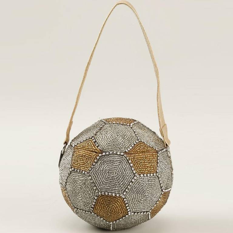 Vintage Embellished Football Bag. 	
Vintage embellished bag featuring a rounded shape, beaded embroidery, a top flap closure, a top handle and an internal logo patch

Colour: Gold, Silver

Material: Beads

Measurements: Circumference: 46