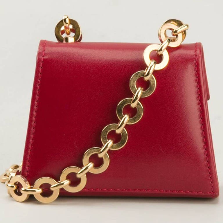 Ferragamo Vintage Mini Shoulder Bag. Red leather mini shoulder bag from Ferragamo Vintage featuring a foldover top with flip-lock closure, a chain shoulder strap and an embossed internal logo stamp.

Measurements:height: 7 centimetres, width: 9