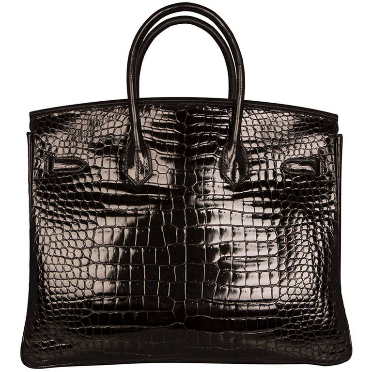Hermès 35cm Black Croc Birkin. This Gorgeous Hermes Birkin bag is 35cm in black croc leather with gold-Tone hardware. The front clasp has the iconic HERMES-PARIS stamp, and on the reverse is the blind stamp embossed into the leather. This is a rare