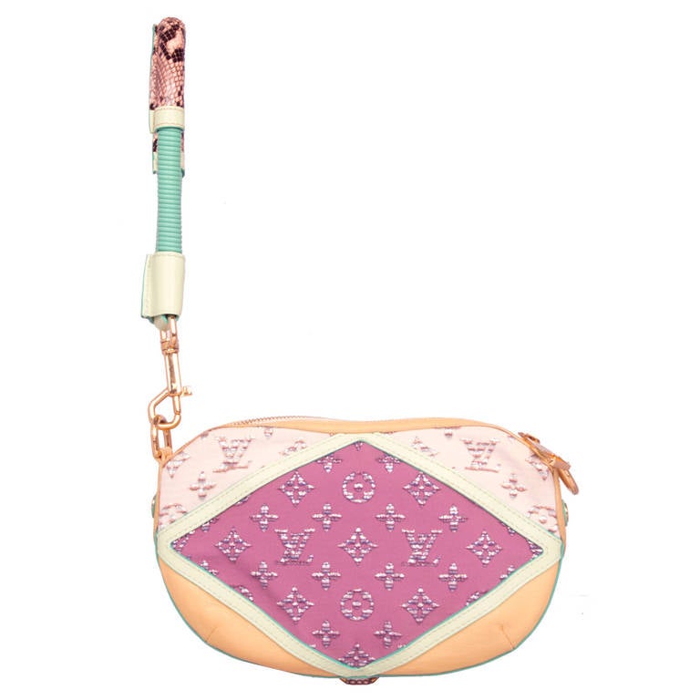 This exquisite Louis Vuitton Nightbird Pochette bag from the 2010 S/S ready-to-wear collection combines a unique blend of vibrant colours, luxurious fabrics and intricate details. This bag features Gold tone hardware, detachable handle, Cream