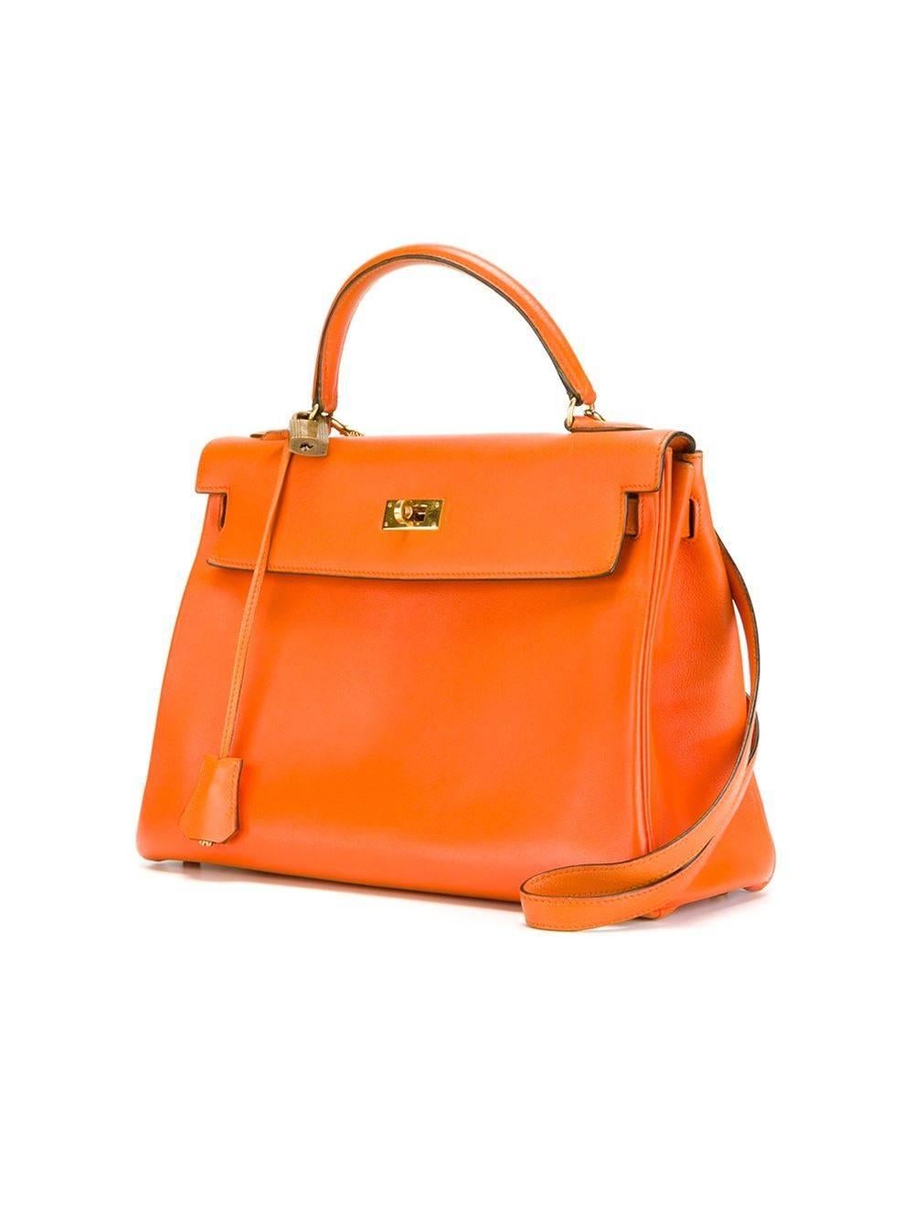 Hermes Vintage Kelly bag in 32cm, in orange leather. This classic bag features gold- plated hardware and comes with it's original lock and key, and shoulder strap.

Colour: Orange

Material: Leather

Measurements: W: 32cm, H: 22cm D:
