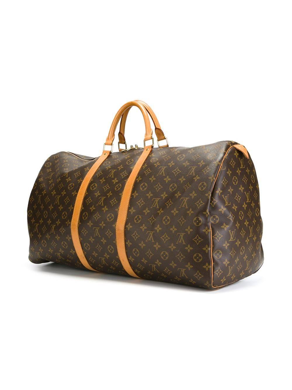 Brown leather 'Speedy' travel bag featuring round top handles, a monogram print, a top zip closure and an embossed logo.

Colour: Brown

Material: Leather 100%

Measurements: W: 61cm H: 35cm D: 27cm Handle: 15cm

Condition: 8.5 out of