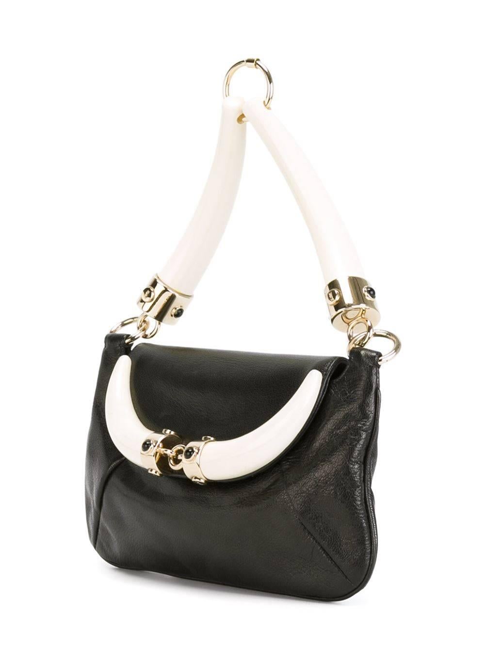 Black buffalo leather 'Mombasa' bag featuring a foldover top with magnetic closure and bone strap and embellishments.

Colour: Black

Material: Leather 70% Plastic 20% Metal (Other) 10%

Measurements: H: 12cm W: 21cm D: 2cm Handle: