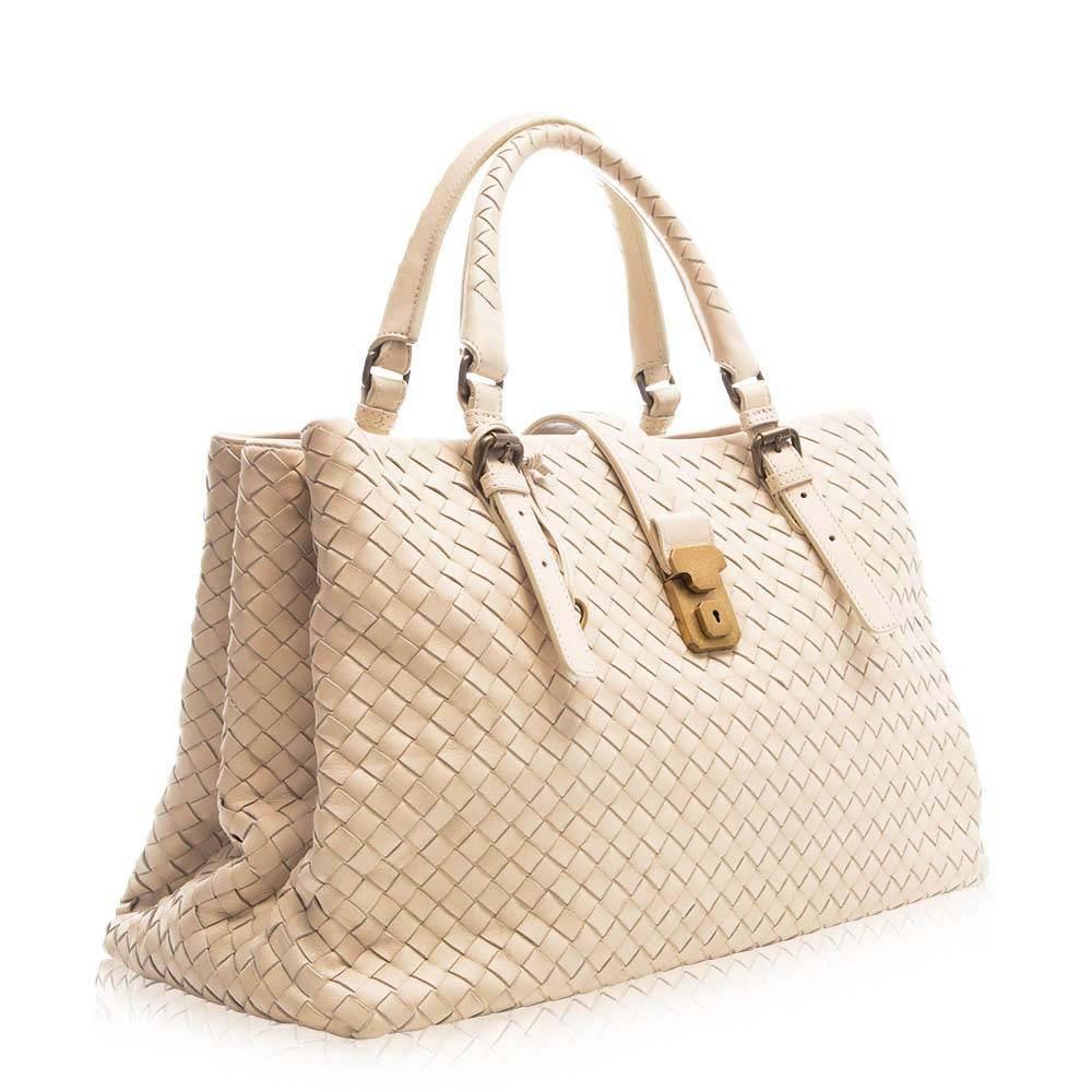 This timeless piece makes for the ultimate day look. The expertly designed leather handbag features gold-plated hardware, spacious compartments, internal zip-pocket, and a lock with key.

This item comes with:

Lock and Key
Colour: Cream