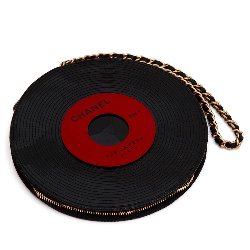 A very cool and unique bag in shape of a vinyl for all music lovers. The amazingly crafted patent leather bag features palladium hardware and a chain link with black leather strap.

This item includes:

Material Care Guide
Colour: Black