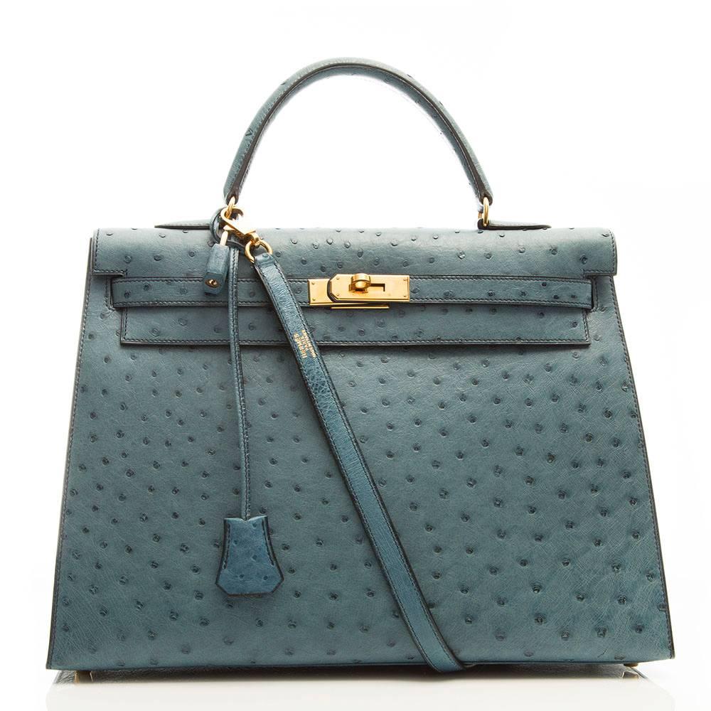 This 35cm Kelly is crafted in Blue Jean Ostrich leather and is accented with gold- plated hardware. Its interior boasts three pockets one zipped and the other two open. The bag comes with the original lock and key, detachable shoulder strap and