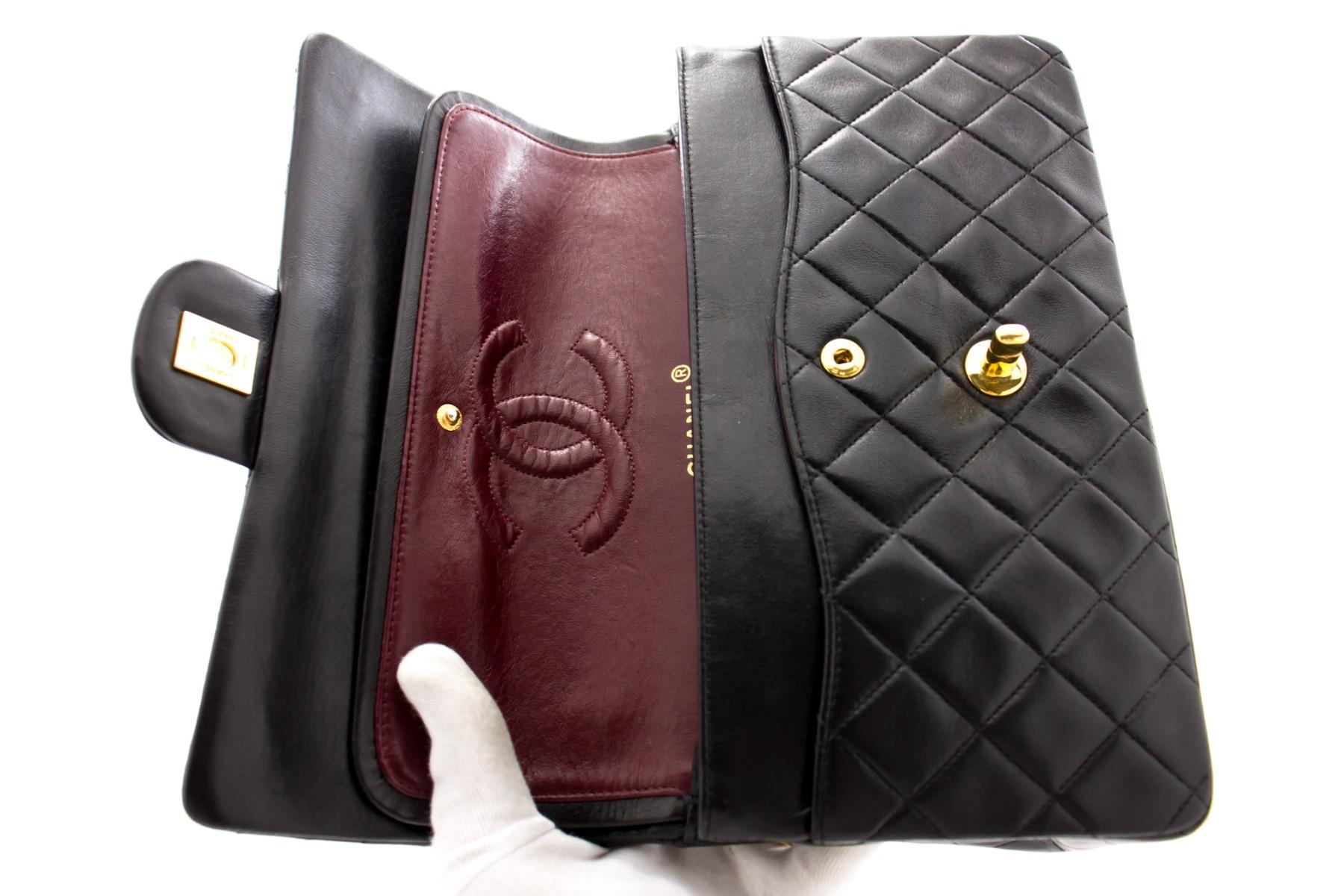 This iconic Chanel 10 inch bag is crafted from quilted black lambskin and features a double flap. On the front flap there is the classic CC logo twist lock, and on the second flap a stud closure with one slip-in pocket. The inside lining is covered