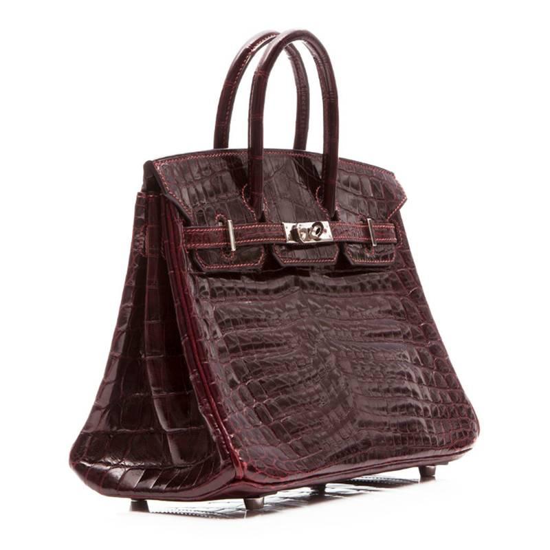 Hermes Birkin Bag in bordeaux Niloticus crocodile leather with Palladium hardware. The interior is lined in dark brown goatskin and boasts one zipped and one open pocket.

This bag comes with its original dustbag. Please note this bag does not