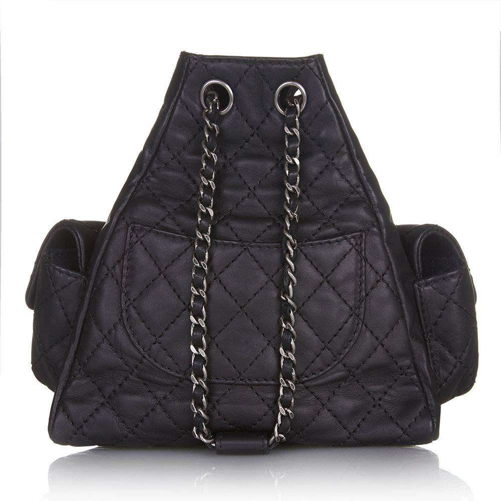 Truly irresistible in miniature form, this Chanel backpack features the brand’s signature quilted black leather and woven chain straps. It is finished with three outer pockets, and a gunmetal zipper down its centre to reveal its main