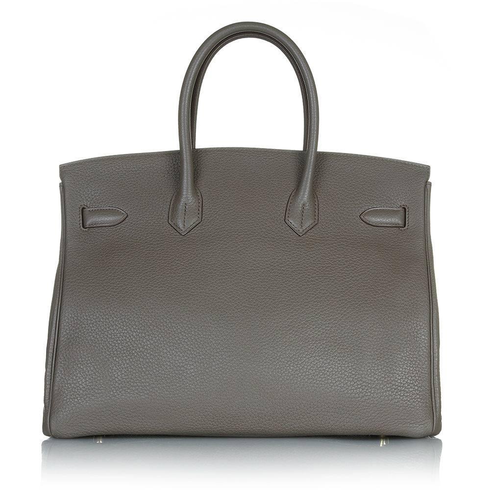 Make a timeless statement with an Hermès Kelly bag in the highly sought-after and wearable shade of Etain. It is crafted from Clemence leather with Lizard oleather inserts, popular for its scratch resistant properties, and brilliantly finished with