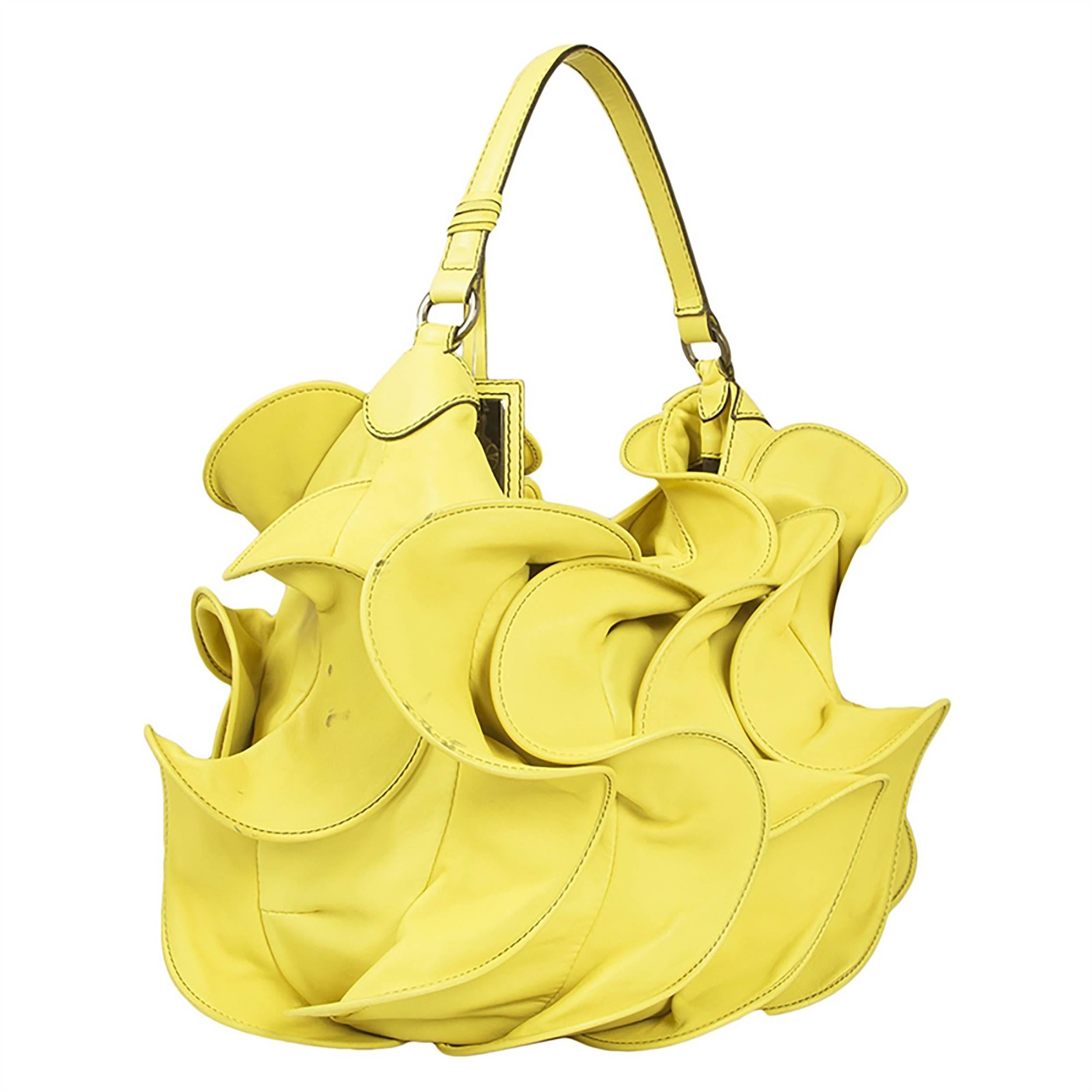 A joyful creation from Valentino brimming with the romantic fantasy at the heart of the brand. This handbag is formed from ripples of yellow leather. Its black-lined interior contains one zipped pocket and two open pockets.

Material: