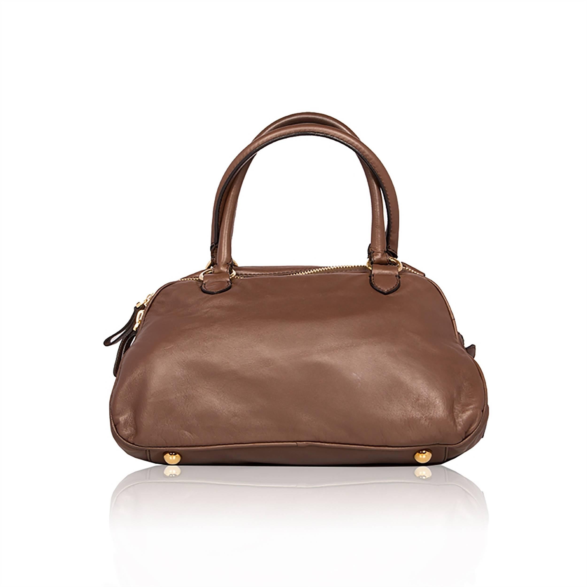 A beautiful design from Valentino, evoking all the Italianate romance of the brand. In brown, this Valentino handbag features a softly pleated detailing across its front, resembling an artisanal twist on a bow. The top-handle bag is finished with