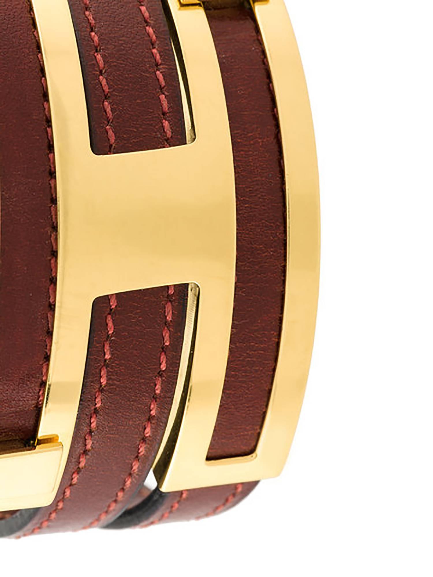 Hermès’ famed leather bracelets are perfect for stacking. This particular design features a dark red leather strap that wraps into an H-shaped clasp. The width of the straps is adjusted by the simple push of the gold-plated dials along the lines of