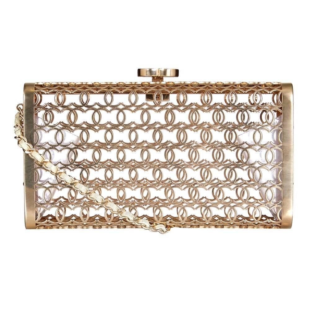 Visit Coco Chanel's home on rue Cambon, and you'll find criss-crossing 'C's hidden throughout her furnishings. This vintage Chanel box-clutch bag features the iconic monogram disguised as a patterned mesh. In pale gold-tones, it is offset with a