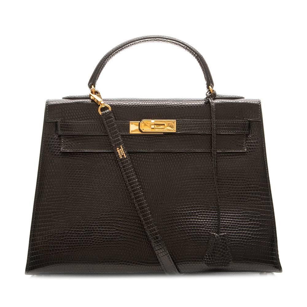 This Hermes Vintage 32cm Black Lizard Kelly Bag is a timeless classic and perfect for any occasion. This bag offers style and elegance adorned with beautiful gold-tone hardware. This also comes with lock & key. 

The bag comes with a Hermes Spa