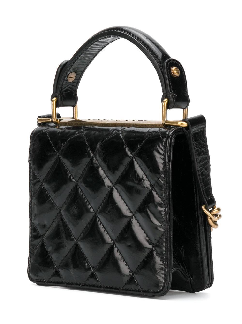 Cute and classic, this Chanel Vintage mini shoulder bag in quilted black lambskin features a chain and leather strap. This bag is accented with gold-tone hardware, a top handle and a foldover top which secures with a logo engraved twist lock