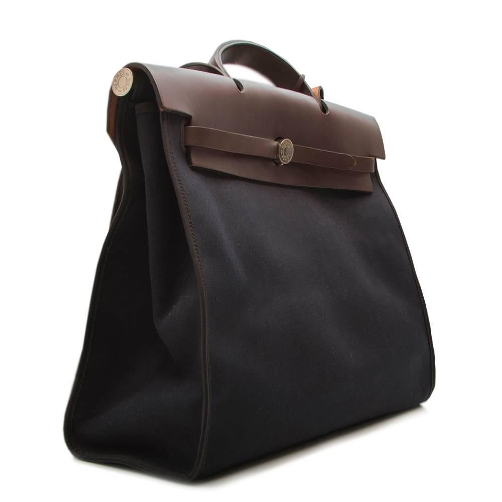 Synonymous with Hermes designs, the Herbag tote features a clean, elegant design that is truly timeless. Brown leather handles and top frame pair nicely with sturdy, heavy weight navy canvas for a lightweight, yet durable bag. This bag is the