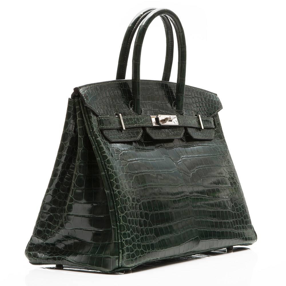 Hermes Birkin Bag in dark green Porosus crocodile leather with Palladium hardware. The interior is lined in dark green goatskin and boasts one zipped and one open pocket.

This bag comes with its original lock and key and dustbag

Colour: Dark