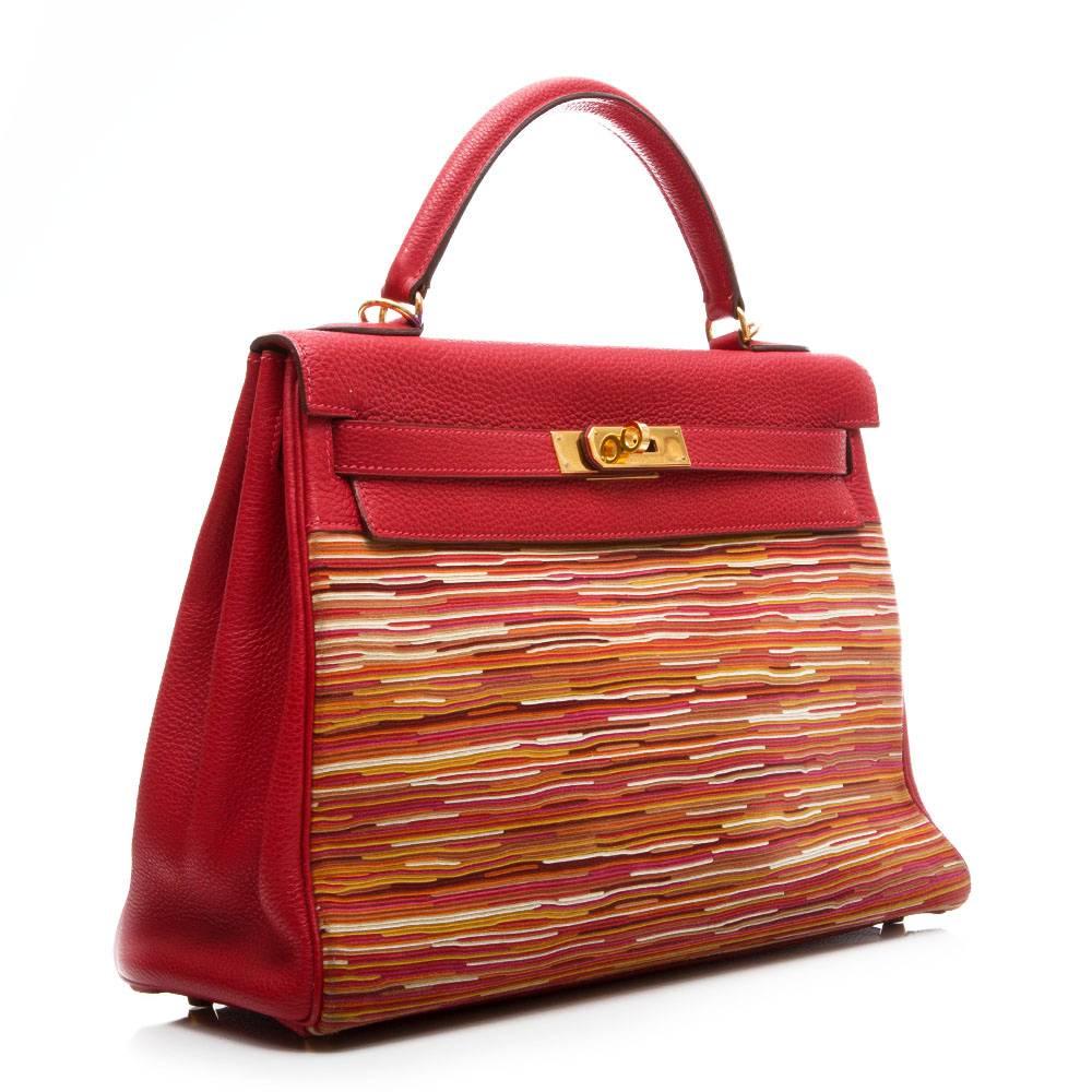 Hermes Vibrato Kelly in red togo leather and gold- plated hardware. The body of the bag is made up from fine individually placed different shades of leather. The interior of the bag is lined in red leather and has one zipped pocket and two open
