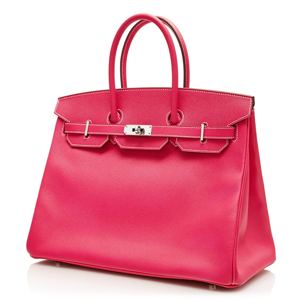 In a rare and enchantingly feminine shade of Rose Tyrien, this 35cm Hermès Birkin tote is a truly dazzling collector's item. It is crafted from Epsom leather, a highly popular hide for its ability to retain its shape, and for its finely-grained