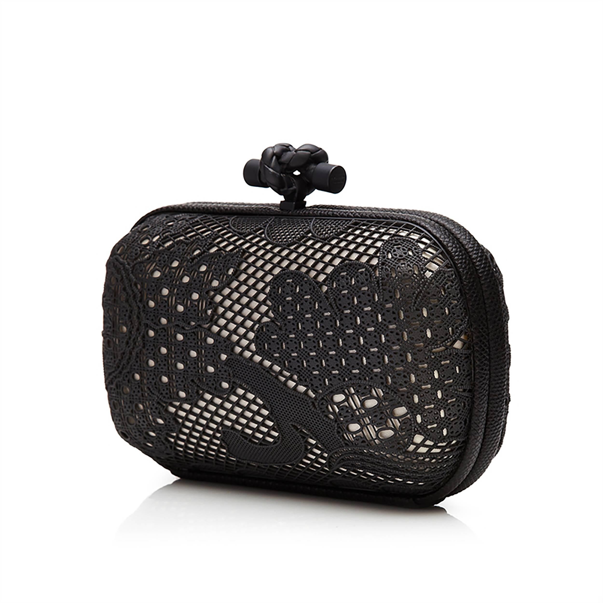This feminine reimagining of Bottega Veneta's famed Knot clutch bag is adorned with an ornate metal overlay resembling lace. Beautifully intricate in its construction, its monochrome exterior is finished with Bottega Veneta's ubiquitous knot-shaped