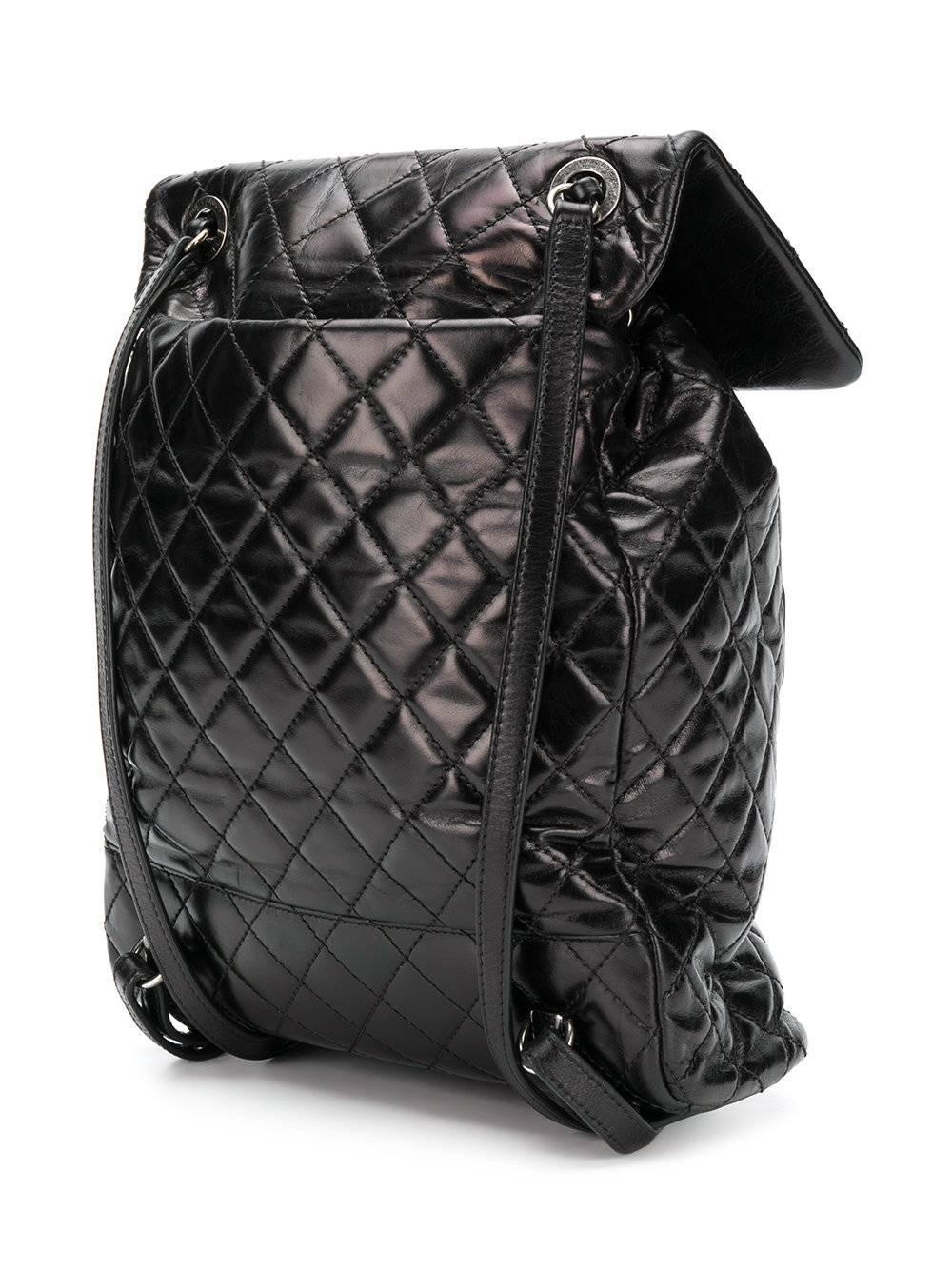 This Chanel backpack is a modern twist on a timeless classic, featuring a foldover top, clasp closer, a front zip pocket, shoulder straps, a quilted effect set off by the silver-tone hardware. This is the perfect bag for any girl on the go,
