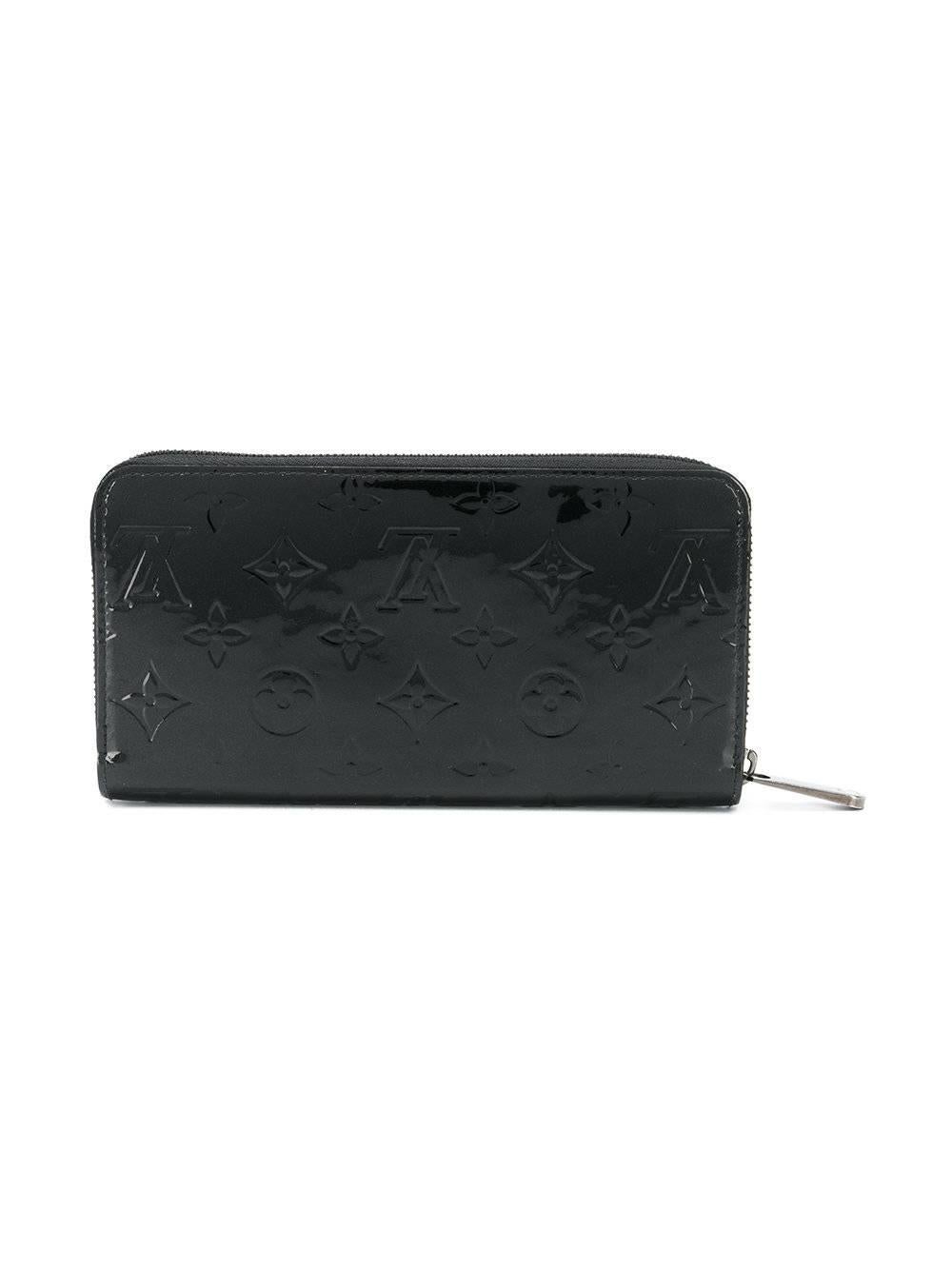 This embossed patent leather wallet from Louis Vuitton features a zipped top accented by silver-tone hardware and opens to reveal two internal compartments, including an internal slip pocket, a coin pocket and multiple card slots.

Colour: