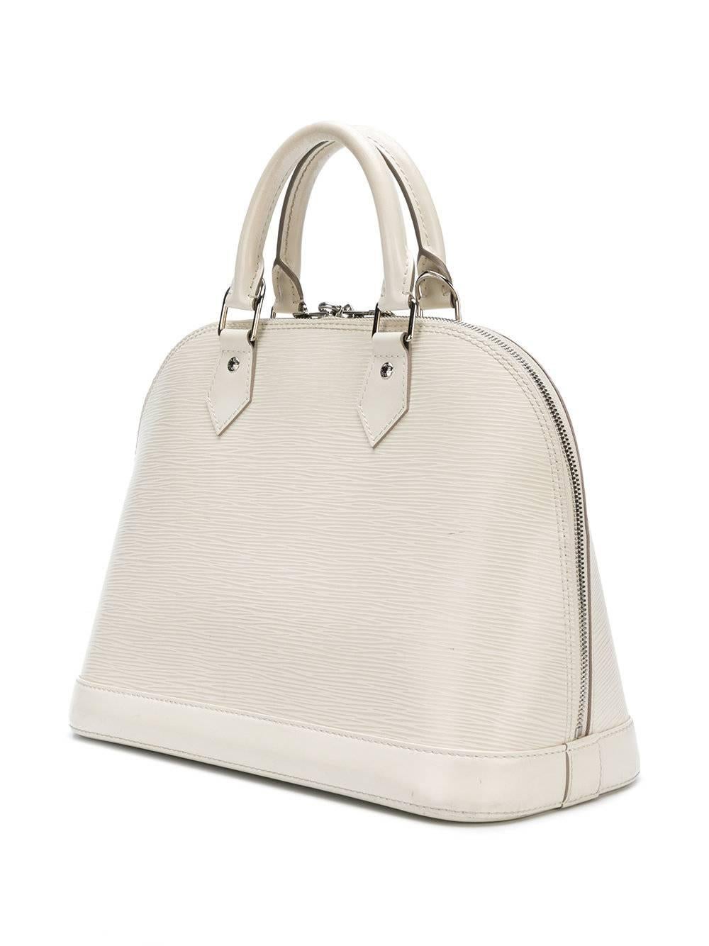 This off-white coloured 'Alma' bag from Louis Vuitton is a modern, yet timeless classic, featuring epi-textured leather, a zip closure, lock with key accented by silver-toned hardware, a beige fabric lining and two small interior slip pockets for