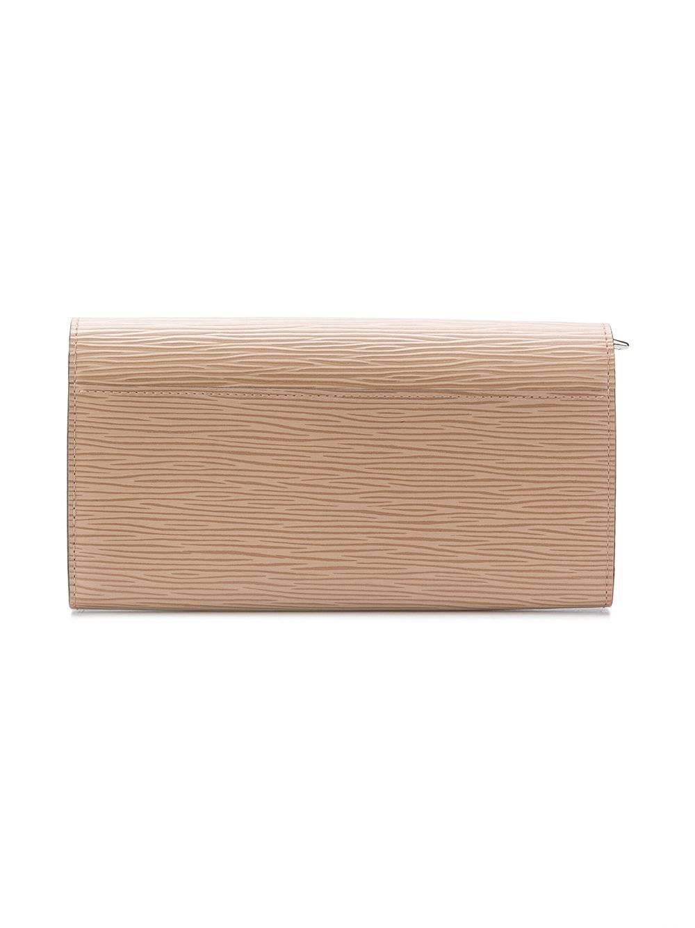 This Dune coloured epi-texture leather 'Sarah' wallet from Louis Vuitton features a foldover top with snap closure, a varnished finish, an interior zipped compartment, multiple interior card slots and an internal logo stamp.

This item comes with