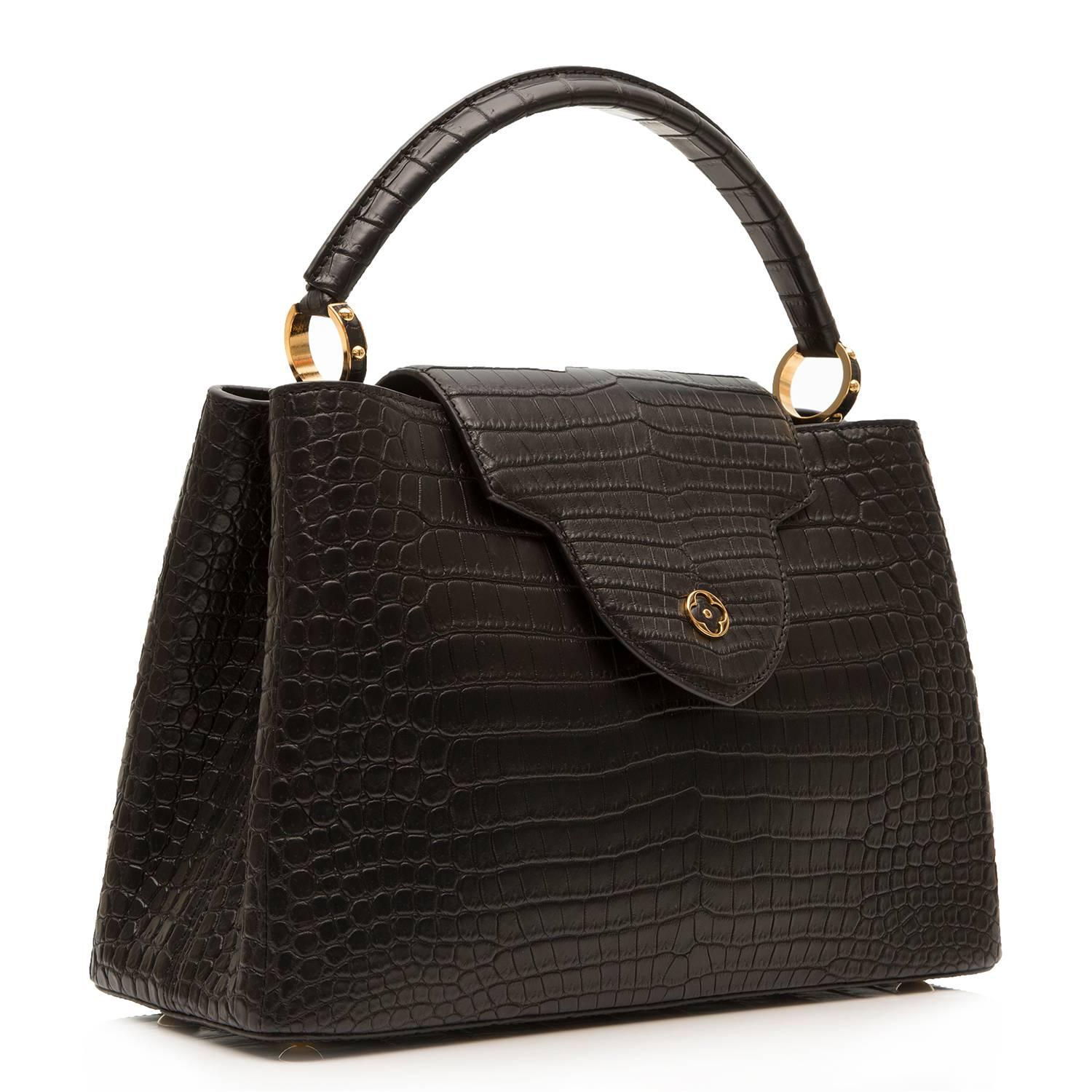 This exquisite Louis Vuitton Capucines bag takes its name from the rue des Capucines in Paris, where Louis Vuitton opened his first store in 1854. Crafted in the rare and precious  skin, it combines refined details, including a semi-rigid handle