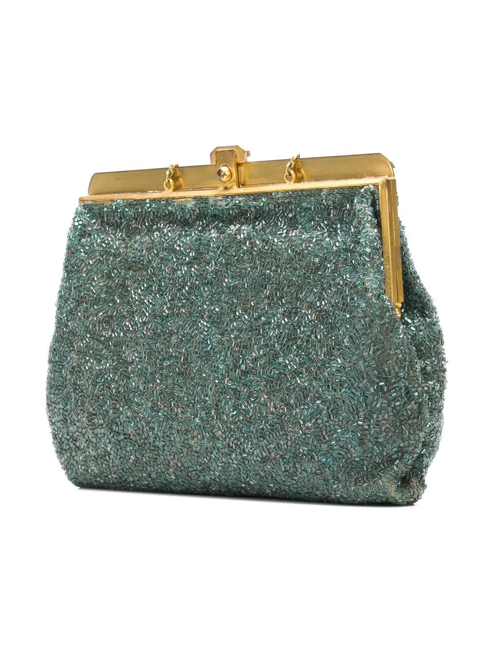 A truly prized vintage handbag from the 1950s. Dazzlingly in its shimmering textures, its evocatively rippled pattern of aqua blue beads is offset with a gold-tone frame. Its top clasp opens to reveal multiple interior compartments and a delicate