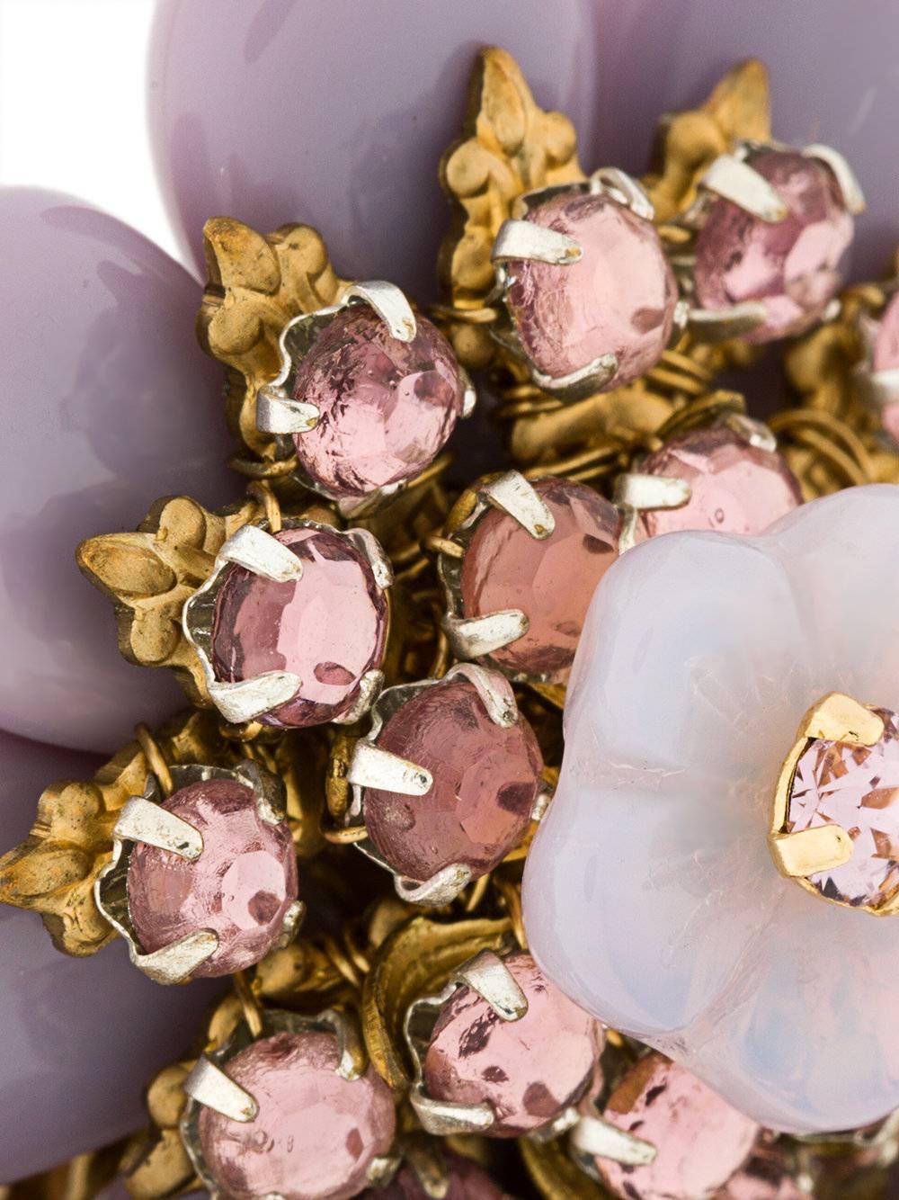 A feminine design with statement appeal, these vintage earrings are from the 1950s. They feature gold-tone and lilac floral details, crystal embellishments and a clip-on fastening. By Stanley Hagler, a designer whose jewellery was acclaimed by Vogue