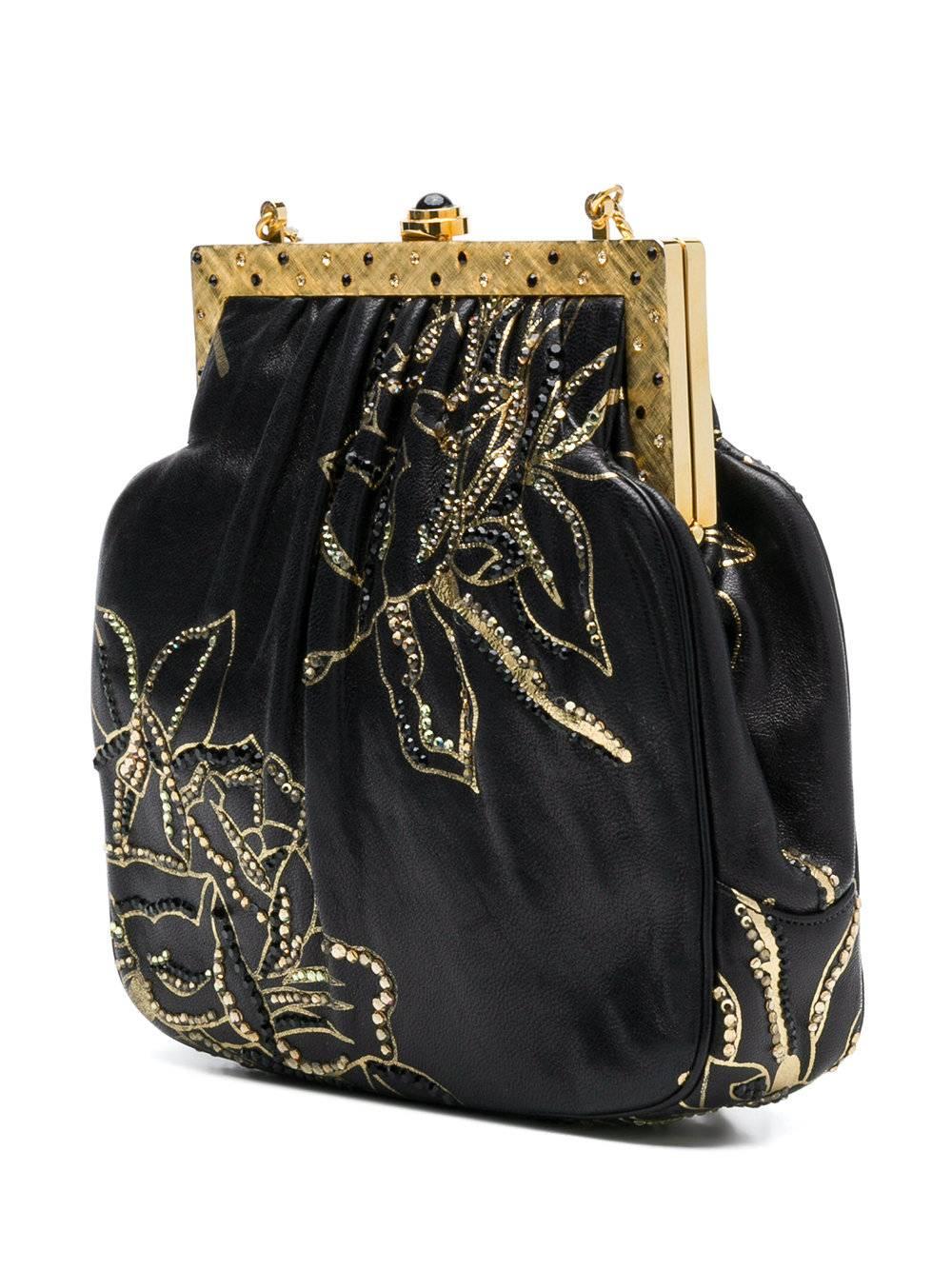 This evening bag from the iconic Judith Leiber is finished with the accents of crystal so inherent to her glittering world. This leather-bodied bag is hand-painted with metallic flowers and framed with brushed gold-tone hardware. Leiber's magical