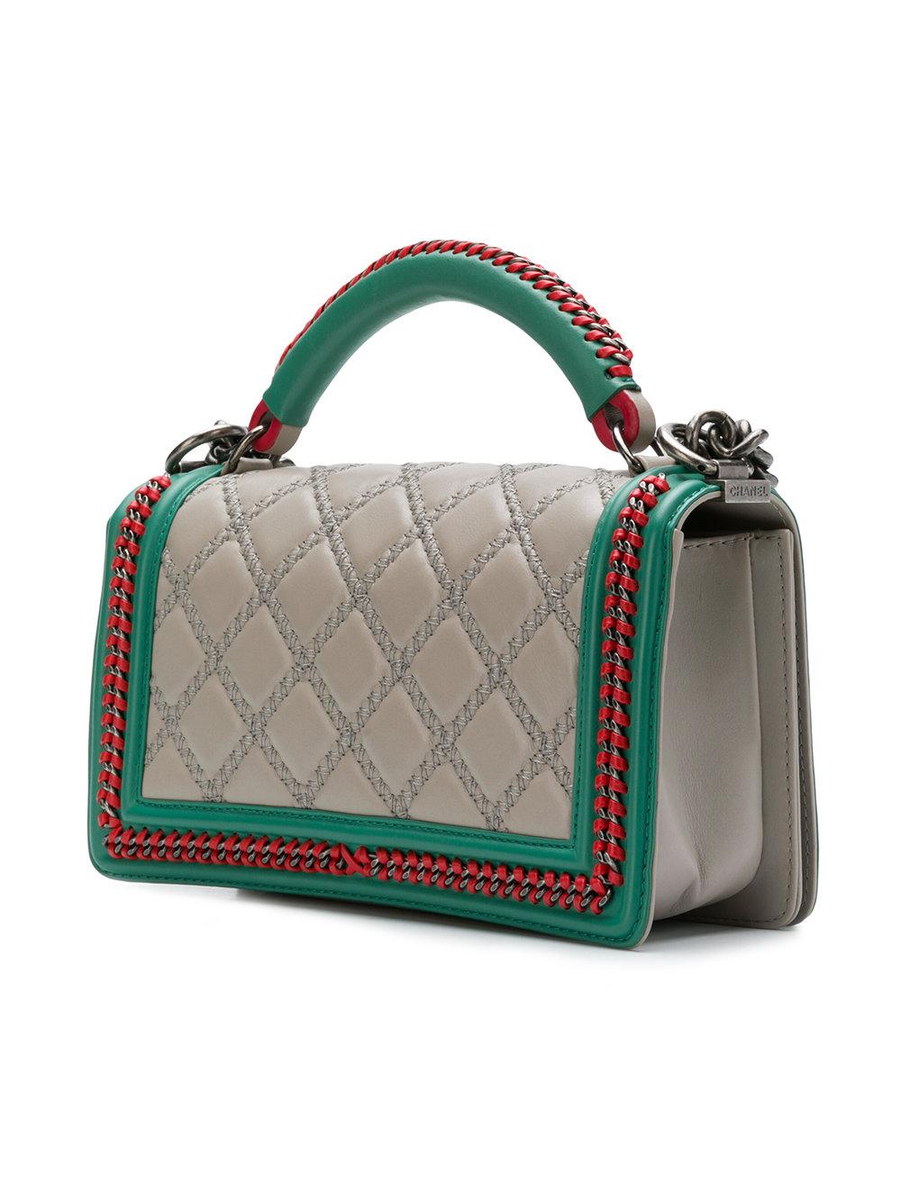 Crafted in a striking combination of beige, red and green lambskin leather, this limited edition tri colour flap Bag from the Chanel Pre-Fall 2015 collection features the iconic quilted diamond pattern, logo push lock and top handle deisgn, an