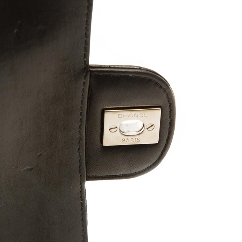 A striking rendition of the iconic Chanel 2.55 handbag that still retains its powers of timelessness. Matte crocodile skin is offset by cool, silver-toned hardware, and features the signature Chanel monogram twist-lock closure, leather-threaded
