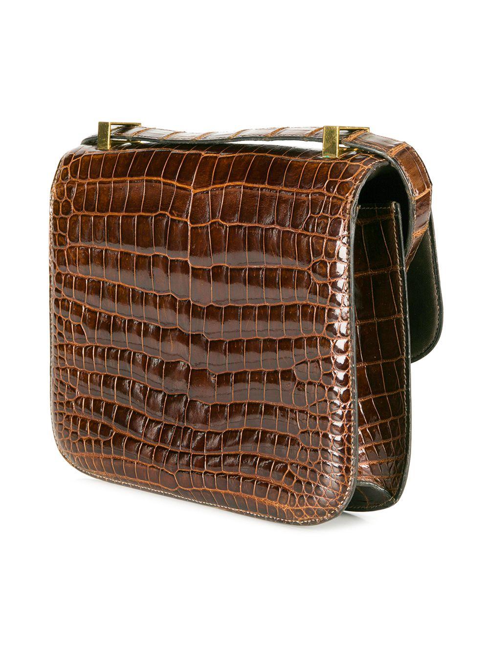 This extremely rare, vintage crocodile Hermès Constance bag comes in a unique and extremely sought after Miel Brown colour. The interior features one spacious interior compartment, containing one wide open slip pocket and one wide pocket with a