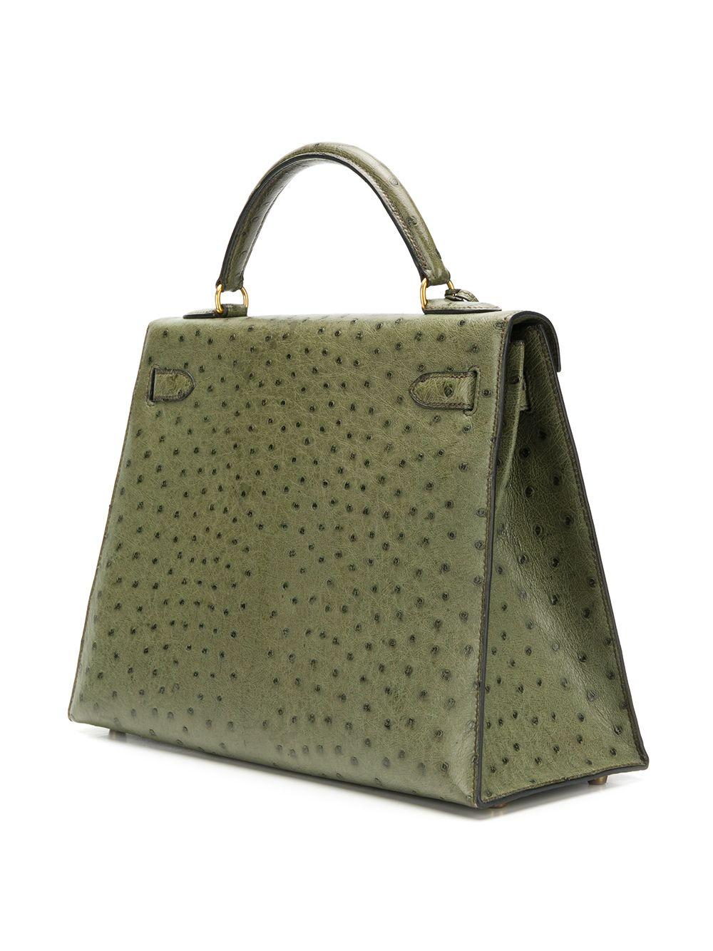 This 32cm Hermès Kelly handbag is crafted in a beautiful and earthy-toned Vert Olive Ostrich leather, and features gold-plated palladium hardware, a top handle and detachable strap. Its interior features a matching goatskin interior with one zipped