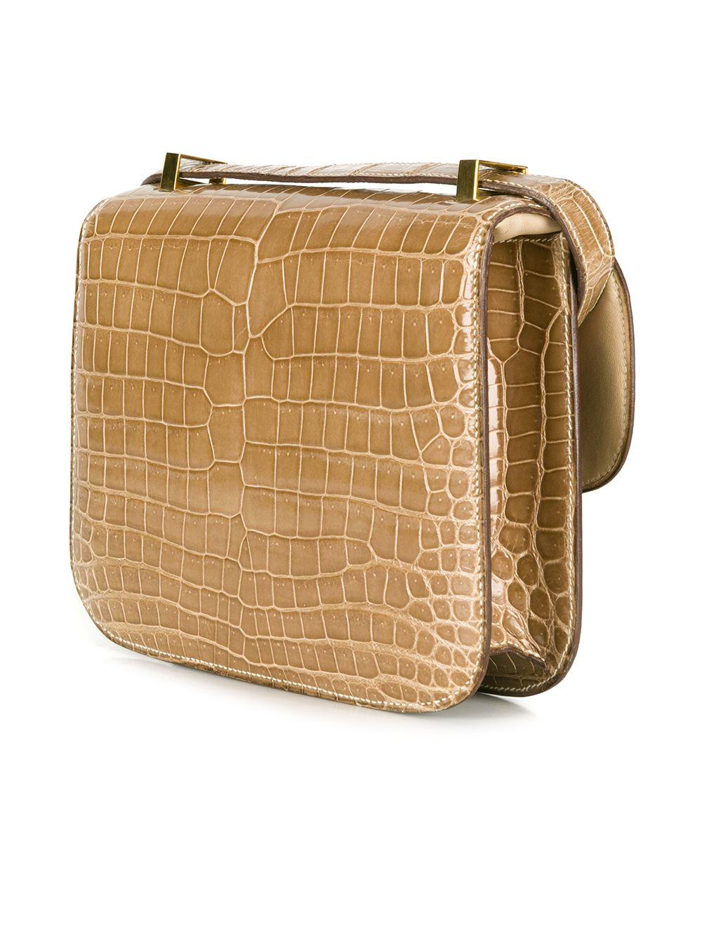 This extremely rare, vintage crocodile Hermès Constance bag comes in a unique and extremely sought after Pousierre Beige colour. The interior features one spacious interior compartment, containing one wide open slip pocket and one wide pocket with a