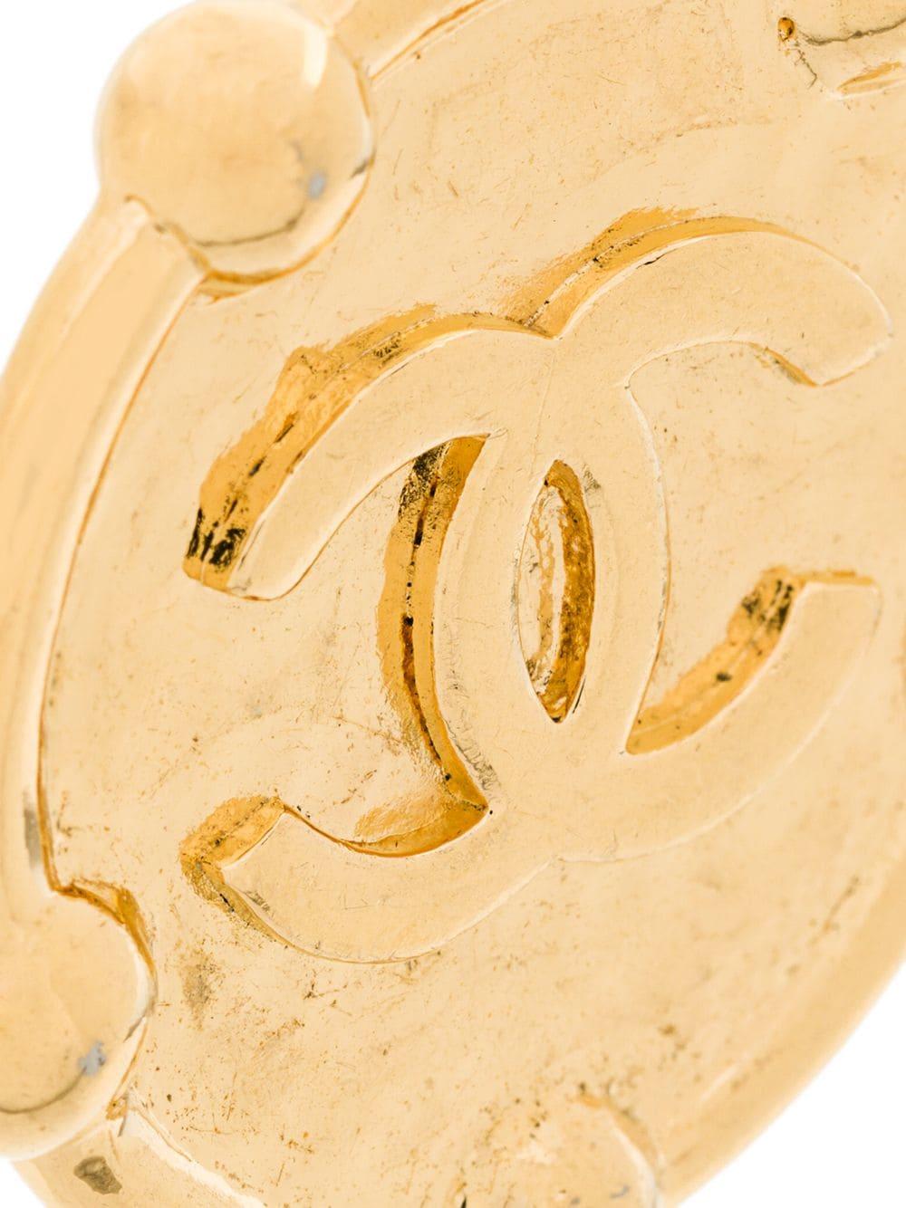 Crafted from gold-tone plated metal, these round oversized earrings are one of Chanel's many trend-setting accessories for the classic yet bold women and feature a clip on fastening, a signature interlocking CC logo and an embossed finish.

This