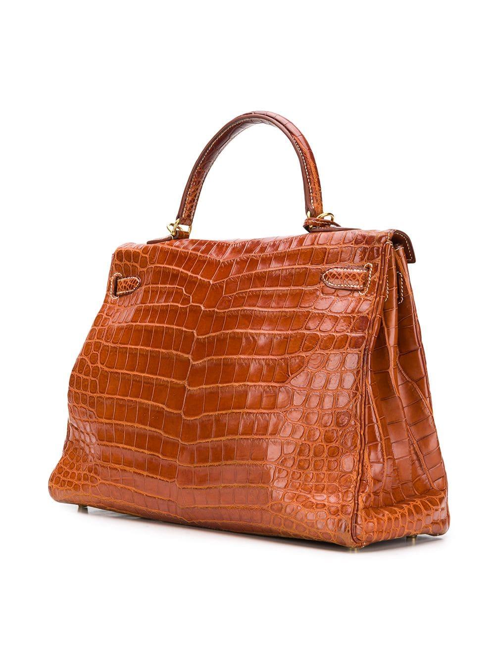 Treat yourself to This extremely rare, Niloticus Crocodile Hermès Kelly bag which comes presented in a unique and extremely sought after shiny Miel Brown colour. A true testament to the quality of the house's craftsmanship, exuding timeless style