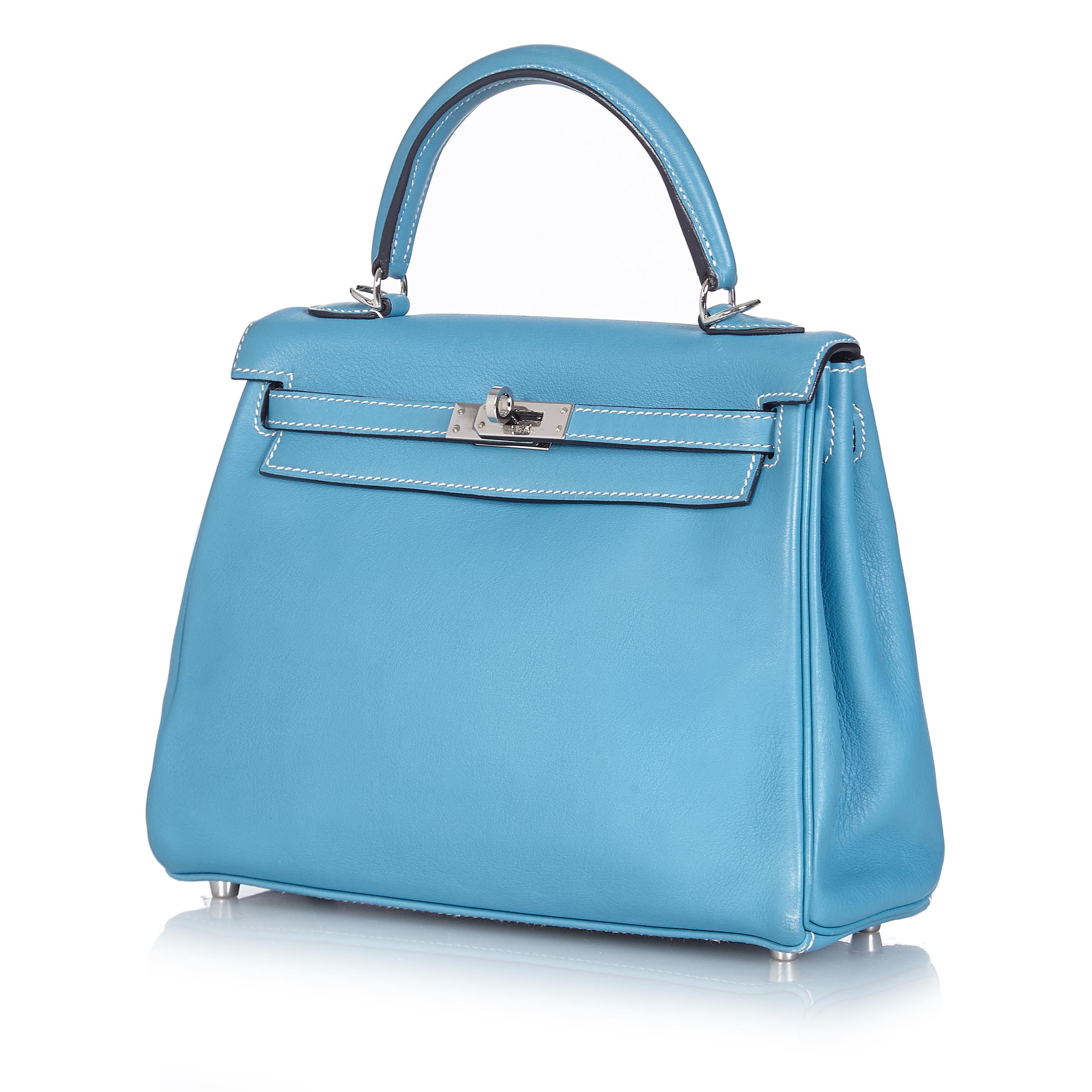 In a highly sought-after compact size, this Hermès Kelly 25 bag makes an irresistibly feminine statement. Expertly crafted in France from a supple blue jean Swift leather, hand stitched by skilled craftsmen in a contrasting white and accented by