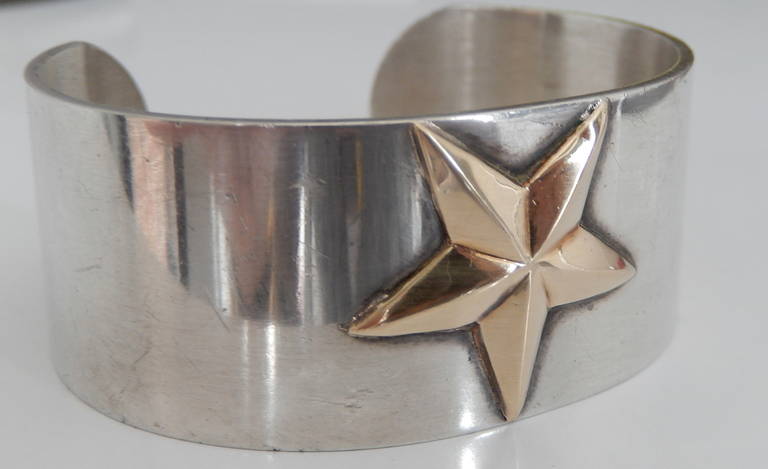 An unusual Pierre Cardin cuff  with a central 14K gold star design. Very minimalist and striking.  Add it to your jewelry to wear on the moon. Signed.
Will fit a size 7 or 7.5 wrist, some flexibility in size.