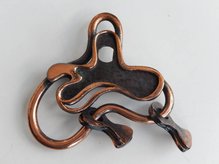 A scarce, cast copper pin with moveable forms by Francisco Rebajes (1907-1990).  This modernist brooch reveals Rebajes' interest in abstraction and surrealism.  An organic, kinetic design with 