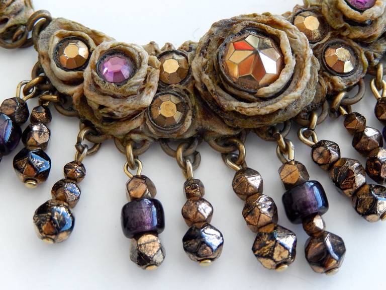 An intricate, scarce resin necklace set with colored and metallic stones by the French jeweler Henry Perichon (1910-1970).  Perichon is credited with inventing a new type of plastic, "rhodoid," that he used to create his innovative