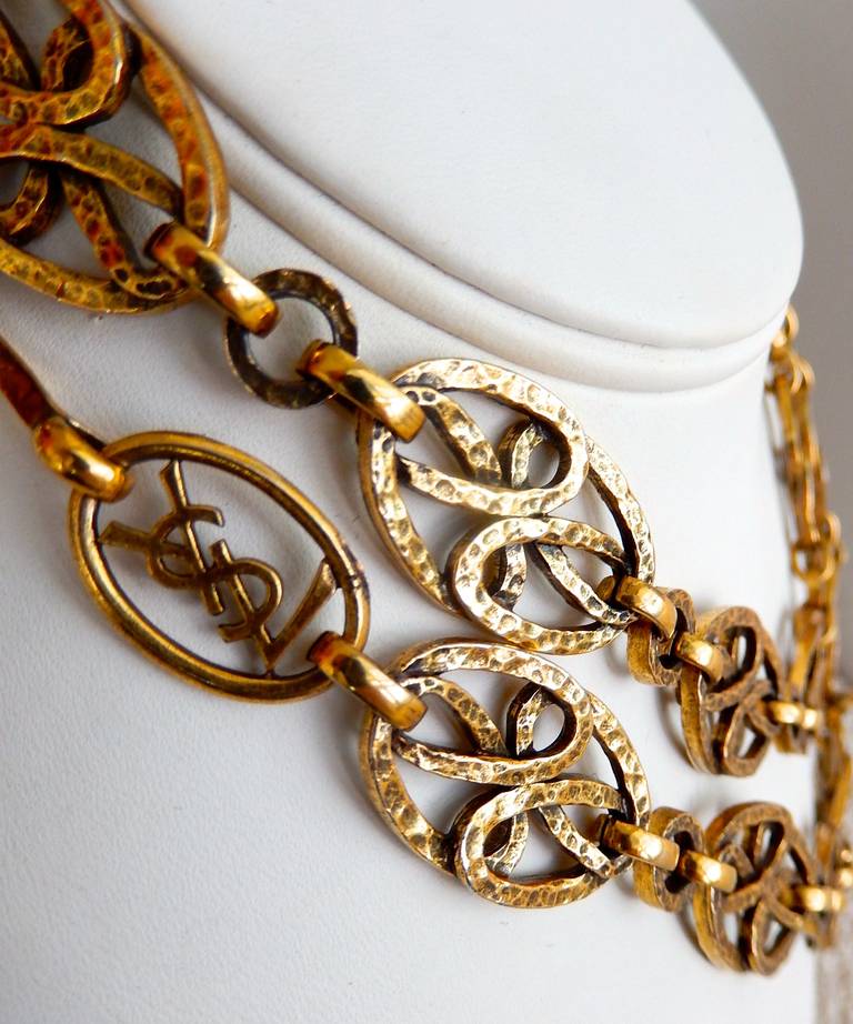 A gilt metal chain by YSL from the 80s with ornamental links that have a hand-hammered metal look.  Hook closure allows chain to be doubled.
