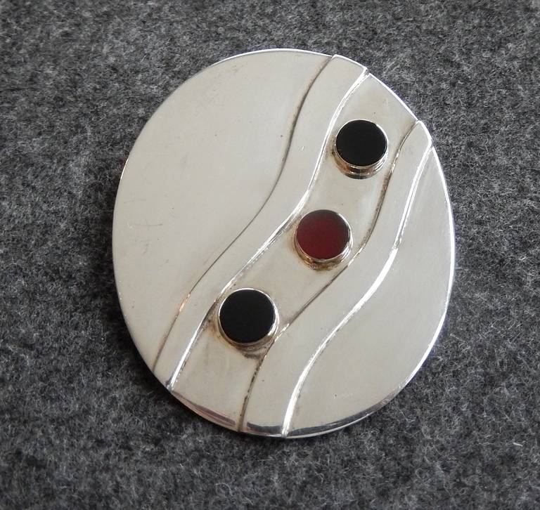 An impressive sterling silver brooch with onyx, carnelian and 14K gold by Pierre Cardin.  It's geometric design is perfect for mod fashion in the Computer Age. The pin can also be worn as a pendant.  Rare.  

